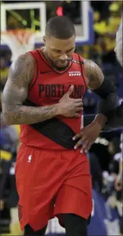  ?? JEFF CHIU — THE ASSOCIATED PRESS ?? Portland Trail Blazers guard Damian Lillard walks to the bench during the second half of Game 2 of the team’s NBA basketball playoffs Western Conference finals against the Golden State Warriors in Oakland Thursday.