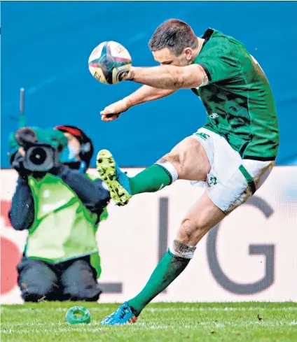  ??  ?? Golden boot: Johnny Sexton kicks one of five successful penalties for Ireland and (below) with the Centenary Quaich award