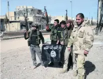  ?? Nazeer Al Khatib / AFP ?? Rebel fighters, part of the Turkey-backed Euphrates Shield alliance, pose with an ISIL flag in the fight for Al Bab.