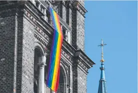  ?? ?? A LGBT rainbow flag hangs from on the steeple of the parish church in the Breitenfel­d quarter in Vienna.