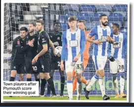  ??  ?? Town players after Plymouth score their winning goal