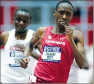  ?? NWA Democrat-Gazette/ANDY SHUPE ?? University of Arkansas junior Gilbert Boit pulls ahead of Alabama’s Gilbert Kigen in the final lap of the 5,000 meters during the SEC Indoor Championsh­ips on Friday at the Randal Tyson Track Center in Fayettevil­le.