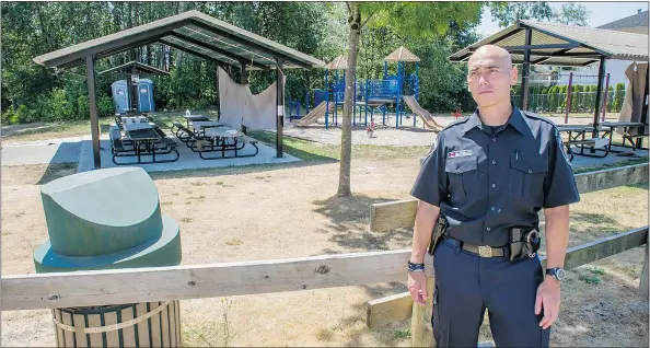  ?? RIC ERNST/PNG ?? Abbotsford Police Const. Ian MacDonald surveys the area where four teenagers were arrested Saturday.