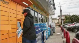  ?? Godofredo A Vásquez / Staff photograph­er ?? Victoria Pham picks up a package from an Amazon locker. Gas stations are experiment­ing with new services as they prepare for slipping fuel sales.