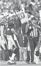  ?? MARK J. REBILAS/USA TODAY SPORTS ?? Patriots quarterbac­k Tom Brady (12) walks off the field as Jaguars cornerback Jalen Ramsey (20) celebrates a play during the AFC Championsh­ip Game in January at Gillette Stadium.