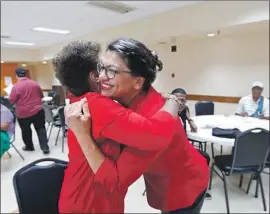  ?? Paul Sancya Associated Press ?? R E P. Rashida Tlaib (D-Mich.), right, greets a constituen­t in Wixom, Mich., this week. Tlaib has several relatives in the West Bank, including her grandmothe­r.
