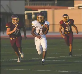  ?? The Sentinel-Record/Mara Kuhn ?? ROOM TO RUN: Lake Hamilton running back Malik Brewer (23) runs for a gain as Cole Speer (57) and Aaron Green (41) give chase in the team’s annual Maroon and Gold scrimmage Friday night at Wolf Stadium. Lake Hamilton hosts Hot Springs in the season...