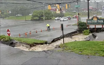  ?? Pittsburgh Post- Gazette ?? Heavy rainfalls caused a sinkhole to open near the entrance of the Waldorf Park Apartments on McKnight Road on July 11.