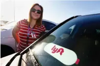  ?? Associated Press ?? ■ Stefanie Lowe, an elementary schoolteac­her, stands next to her car after a “walk-in” for higher pay and school funding in Phoenix.