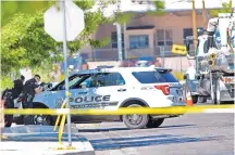  ?? JIM THOMPSON/JOURNAL ?? Albuquerqu­e Police Department SWAT officers surrounded a house near Broadway and Trumbull SE Tuesday morning trying to arrest a man who they say hit a Water Authority worker on the face with a gun. Eric Mojarro, 31, was taken into custody several hours...