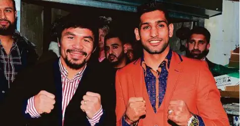  ?? Rex Features ?? Manny Pacquiao (left) announced on his Twitter page that he is lining up a fight with Amir Khan (right), but the Filipino legend’s promoter Bob Arum, however, is sceptical about the bout actually taking place.