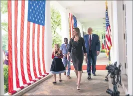  ?? DOUG MILLS — THE NEW YORK TIMES ?? Judge Amy Coney Barrett and President Donald Trump walk to the Rose Garden of the White House for the formal announceme­nt of her nomination to the Supreme Court.