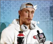  ?? STEVE LUCIANO / ASSOCIATED PRESS ?? San Francisco tight end George Kittle jokes with WWE’s Roman Reigns saying he would match Reign’s Royal Rumble win on Sunday by winning the title among his 49ers’ teammates.