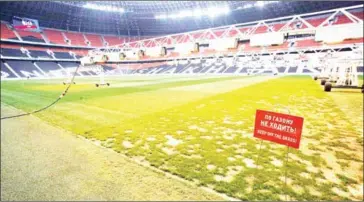  ?? ALEKSEY FILIPPOV/AFP ?? A sign reading ‘Keep off the grass’ stands on the pitch of Ukraine’s Donbass Arena Stadium in Donetsk on April 18.