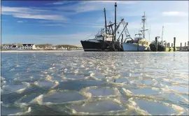  ?? JULIE JACOBSON — THE ASSOCIATED PRESS ?? Fishing trawlers sit on the frozen harbor of Lake Montauk surrounded by thin sheets of ice inMontauk, N.Y., on Sunday. A quick study of the brutal American cold snap found that the Arctic blast really was a freak of nature.