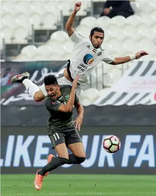  ?? Photo by Ryan Lim ?? Al Jazira’s Musallem Fayez vies for the ball against Emirates’ Murad Batna during their Arabian Gulf League match at Mohammed bin Zayed Stadium in Abu Dhabi. —