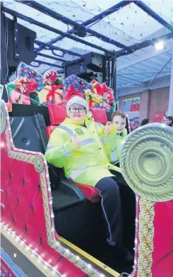  ?? ?? Top tradition Young volunteers Mark Millar and Ryan Kearney helped to launch the sleigh tour