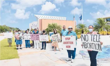  ?? THE PACIFIC DAILY 2021 ?? Members of the Catholic Pro-Life Committee protest outside in front of the Guam Congress Building in the capital city of Hagatna.