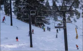  ?? PAUL KITAGAKI JR. — THE SACRAMENTO BEE ?? Skiers and snowboarde­rs go down one of the runs at Palisades Tahoe on Jan. 11. The popular spot has plenty of fresh snow for outdoor enthusiast­s.