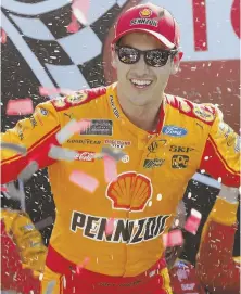  ?? AP PHOTO ?? HE’LL TAKE IT: Joey Logano celebrates after winning the Toyota Owners 400 yesterday at Richmond Internatio­nal Raceway in Richmond, Va.