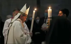  ?? PHOTOS BY REMO CASILLI — POOL PHOTO VIA AP ?? Pope Francis celebrates the Easter Vigil in a nearly empty St. Peter’s Basilica as coronaviru­s pandemic restrictio­ns stay in place for a second year running April 3at the Vatican.