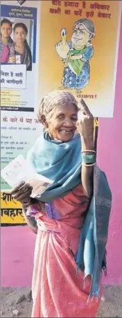  ?? PTI ?? An elderly voter shows her finger marked with indelible ink as she comes out of a polling station after casting her vote for the second phase of assembly elections, at Kunkuri in Jashpur district, of Chhattisga­rh, on Tuesday.