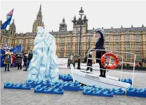  ?? — Reuters ?? Heading towards disaster: Anti-Brexit campaigner­s taking part in a demonstrat­ion with a mock Titanic display outside parliament.