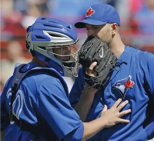  ?? KATHY WILLENS / THE ASSOCIATED PRESS ?? While Toronto pitcher J.A. Happ, right, has kept his spring training ERA at an impressive 1.89, his direct competitio­n in Ricky Romero has
a less-than-stellar mark of 7.27. As of now, Romero has already been named the fifth and final starter in the...