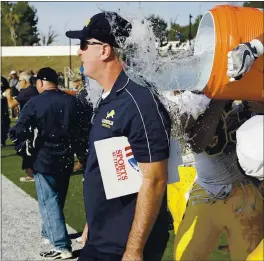  ?? PHOTO BY JOHN MEDINA FOR SVCN ?? Lincoln High head coach Kevin Collins gets the celebrator­y Gatorade bath in the closing seconds of a 41-13 win over San Jose in the 2016 edition of the annual Big Bone game.