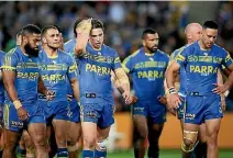  ?? PHOTOS: GETTY IMAGES ?? The dream continues for the written off North Queensland Cowboys, left, but it’s season over for the Parramatta Eels, right.