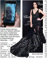  ?? — AFP Dorra Zarrouk ?? French- Swiss director Jean- Luc Godard addresses a press conference through a mobile phone video link, from his home in Switzerlan­d on Saturday.