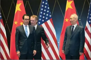  ?? The Associated Press ?? TRADING PLACES: United States Trade Representa­tive Robert Lighthizer, center, changes position with Treasury Secretary Steven Mnuchin, left, as Chinese Vice Premier Liu He looks on as they pose for a photo Wednesday at the Xijiao Conference Center in Shanghai.