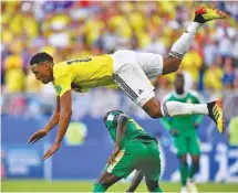  ?? THE ASSOCIATED PRESS ?? Colombia’s Yerry Mina, top, jumps over Senegal’s Sadio Mane in pursuit of the ball during their World Cup Group H finale Thursday in Samara, Russia. Colombia won 1-0 and won the group to advance to the knockout stage.