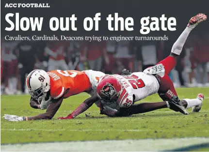  ?? ERIN EDGERTON/ASSOCIATED PRESS ?? Virginia wide receiver Lavel Davis Jr., left, is tackled by North Carolina State cornerback Shyheim Battle. The Cavaliers have lost two games in a row.