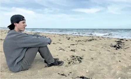  ?? GALEN EAGLE/SPECIAL TO THE EXAMINER ?? Thomas Beamish-Lavoie, a Grade 12 student at St. Peter Secondary School, reflects on Juno Beach in Normandy, France.