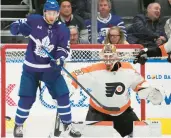  ?? FRANK GUNN/THE CANADIAN PRESS ?? Philadelph­ia Flyers goaltender Felix Sandstrom watches the puck as Toronto Maple Leafs’ Michael Bunting stands in front during the third period on Wednesday night.