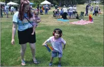  ?? ?? Page Cosmiano of Fairfield and her 4-year-old son, Nolan, and 8-month-old daughter, Copelyn, dance to “One Kiss” by Calvin Harris and Dua Lipa at Vacaville's Pride in the Park event at Andrews Park.