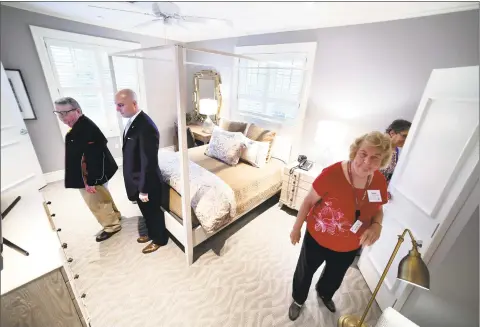  ?? Arnold Gold / New Haven Register ?? People view a bedroom of the Connecticu­t Fisher House on the grounds of the West Haven campus of the VA Connecticu­t Healthcare System.