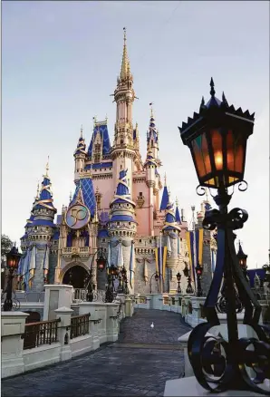  ?? Associated Press file photo ?? The Cinderella Castle at the Magic Kingdom at Walt Disney World is seen with the the crest to celebrate the 50th anniversar­y of the theme park in August 2021 in Lake Buena Vista, Fla. The idea was presented to Florida lawmakers 55 years ago: Let Disney form its own government and in exchange it would create a futuristic city of tomorrow. That city never materializ­ed, but Walt Disney World became an economic juggernaut, and its government retained unpreceden­ted powers. Five decades later, Gov. Ron DeSantis asked lawmakers to end Disney’s government.