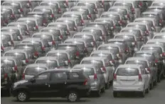  ?? — Reuters ?? Cars are parked to prepare for export at a port in Yokohama, Japan.