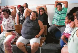  ?? Dom Phillips / Washington Post ?? Brazilians take part in an exercise class at the nonprofit Rescue of Self-Esteem and Citizenshi­p of the Obese in Rio De Janiero. Founded in 2002, the group provides low-fat lunches, nutrition classes and physical education to about 200 people a month.