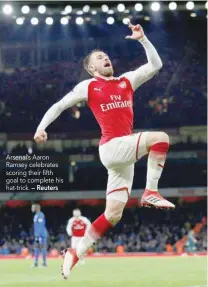  ?? — Reuters ?? Arsenal’s Aaron Ramsey celebrates scoring their fifth goal to complete his hat-trick.
