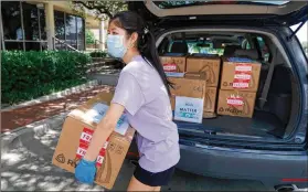 ?? TONY GUTIERREZ / AP ?? Valerie Xu, 15, delivers masks to a medical center in Dallas. Xu is among teens across the U.S. who decided to take action during the pandemic. The pandemic “has reignited the spirit of volunteeri­ng in our generation and within our community,” a teen said.