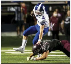  ?? (Arkansas Democrat-Gazette/Stephen Swofford) ?? Bryant quarterbac­k Carson Burnett (16) stiff-arms Benton linebacker Beau Wright during the Salt Bowl on Saturday night at War Memorial Stadium in Little Rock. More photos available at arkansason­line.com/829salt.