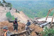  ?? POOL PHOTO VIA THE ASSOCIATED PRESS] ?? Members of search and recovery teams search for survivors in the debris of a massive, rain-fueled landslide Saturday in the village of Queja, in Guatemala, in the aftermath of Tropical Storm Eta. [ESTEBAN BIBA/