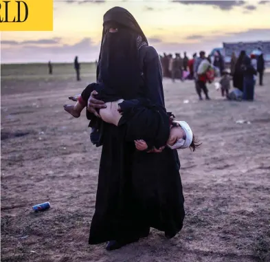  ??  ?? A woman carries her injured child while walking toward members of the Kurdish-led Syrian Democratic Forces on Monday after she left Baghouz, the last Syrian village held by the Islamic State of Iraq and the Levant. BULENT KILIC / AFP / GETTY IMAGES