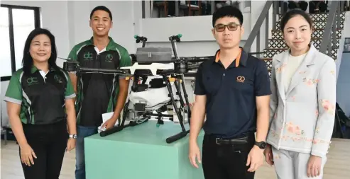  ?? CONTRIBUTE­D PHOTO ?? DC CRUZ Trading Corp▪ Chief Executive Officer Ruby Tania Cruz (left) with Dragon Drone Chief Marketing Officer David Cruz (second from left) with some of their partners during the inaugurati­on of Dragon Drone’s Showroom at Barangay Tangub in Bacolod City yesterday, October 7▪