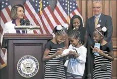  ?? Chip Somodevill­a/Getty Images ?? Seven-year-olds, from left, Seilah Tappin, Dani Hebron and Seilah’s twin sister Shilo, take notes Friday during a news conference held by House Minority Leader Nancy Pelosi, DCalif., behind the podium, in the Capitol in Washington, D.C. The twins’...