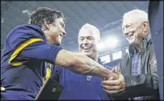  ?? AP ?? Highland Park quarterbac­k John Stephen Jones is greeted by father Stephen (center) and grandfathe­r Jerry after leading his team to a Texas state title on Dec. 17.