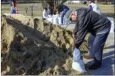  ?? GREG DERR — THE QUINCY PATRIOT LEDGER VIA AP ?? John Woodland fills a sandbag to use at his home, Thursday in Scituate, Mass., ahead of Friday’s expected storm, predicted to bring high winds and the potential for coastal flooding.